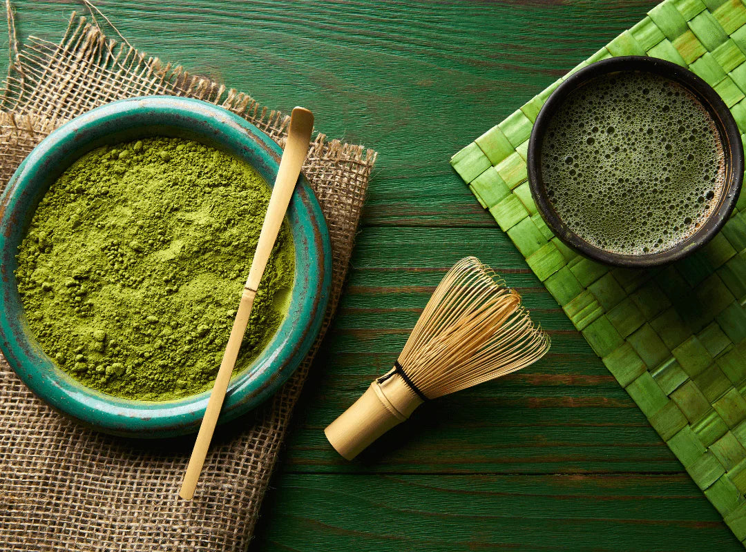 Premium matcha powder and matcha latte in a cup, showcasing the vibrant green colour and health benefits of matcha tea."