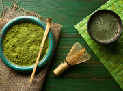 Premium matcha powder and matcha latte in a cup, showcasing the vibrant green colour and health benefits of matcha tea."