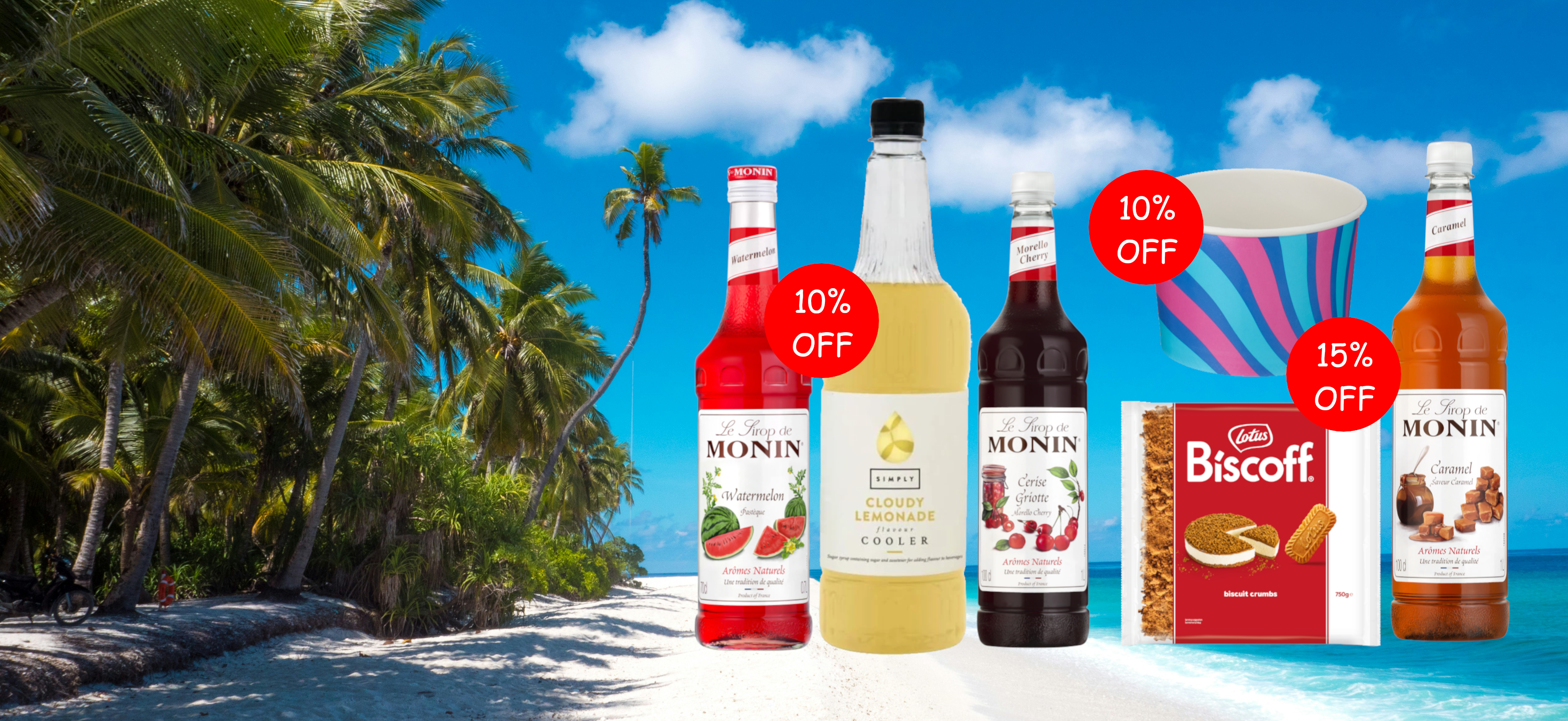 A promotional beach scene with several Monin syrup bottles, a bottle of vanilla syrup, a box of Biscoff cookies, and a striped paper cup on a white sandy beach with palm trees under a blue sky.