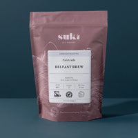 Tea package with 'suki' branding on a dark background
