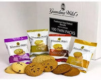 Grandma Wild's twin packs biscuits display in front of branded box featuring fruit and lemon, oaty, choc chip and ginger with loose cookies.