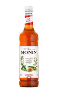 Bottle of Monin hot honey syrup on a white background