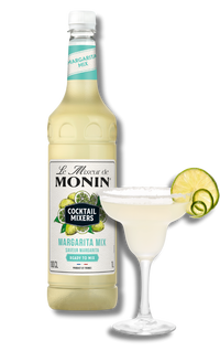Monin Margarita Mix bottle with a cocktail and lime wheel on a white background