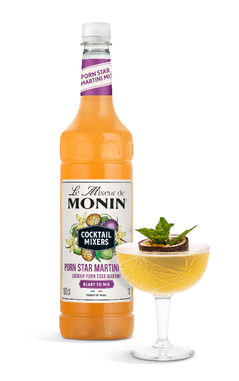 Monin cocktail mixer bottle with a cocktail garnished with a mint leaf on a white background