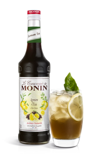 Monin Lemon Tea syrup bottle with a glass of lemon tea on a white background