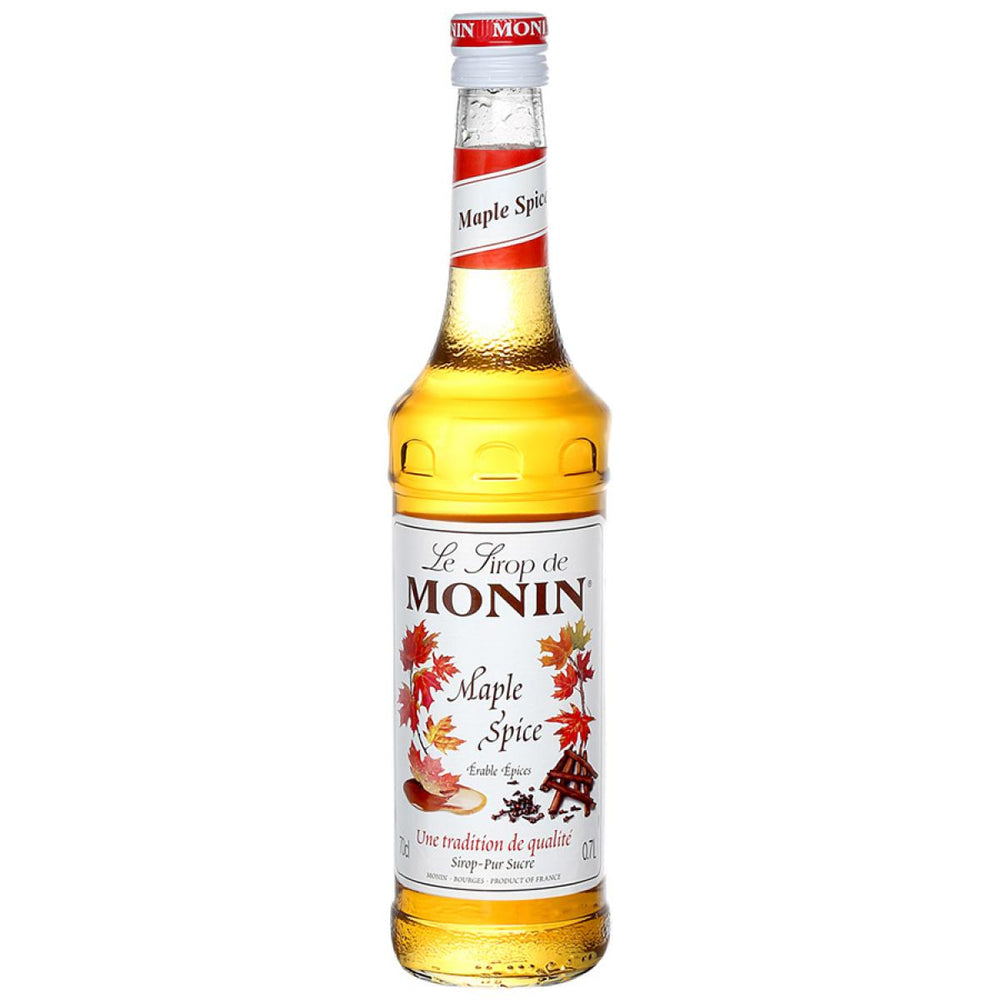 A bottle of Monin Maple Spice Syrup with a label showing maple leaves and text.