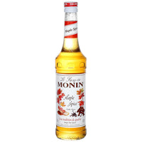 A bottle of Monin Maple Spice Syrup with a label showing maple leaves and text.