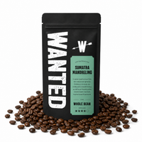 A black stand-up coffee bag labeled WANTED Sumatra Mandheling whole bean coffee, surrounded by scattered roasted coffee beans on a white background.