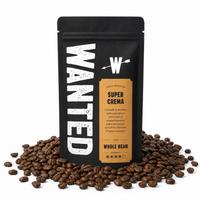 A black stand-up coffee bag labeled WANTED Super Crema Whole Bean, surrounded by scattered roasted coffee beans on a white background.