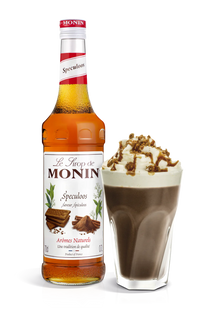 A bottle of Monin Speculoos Syrup with a decorative image of a coffee beverage topped with whipped cream and chocolate sprinkles.