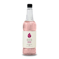 A bottle of Simply Rose Flavored Syrup with a black cap and a cream-colored label, containing pink liquid, shown on a white background.