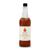 A bottle of Simbas Speculocus Caramelised Biscuit Syrup, featuring amber-brown syrup inside a clear glass bottle with a cream-colored label and a black cap, set against a plain white background.