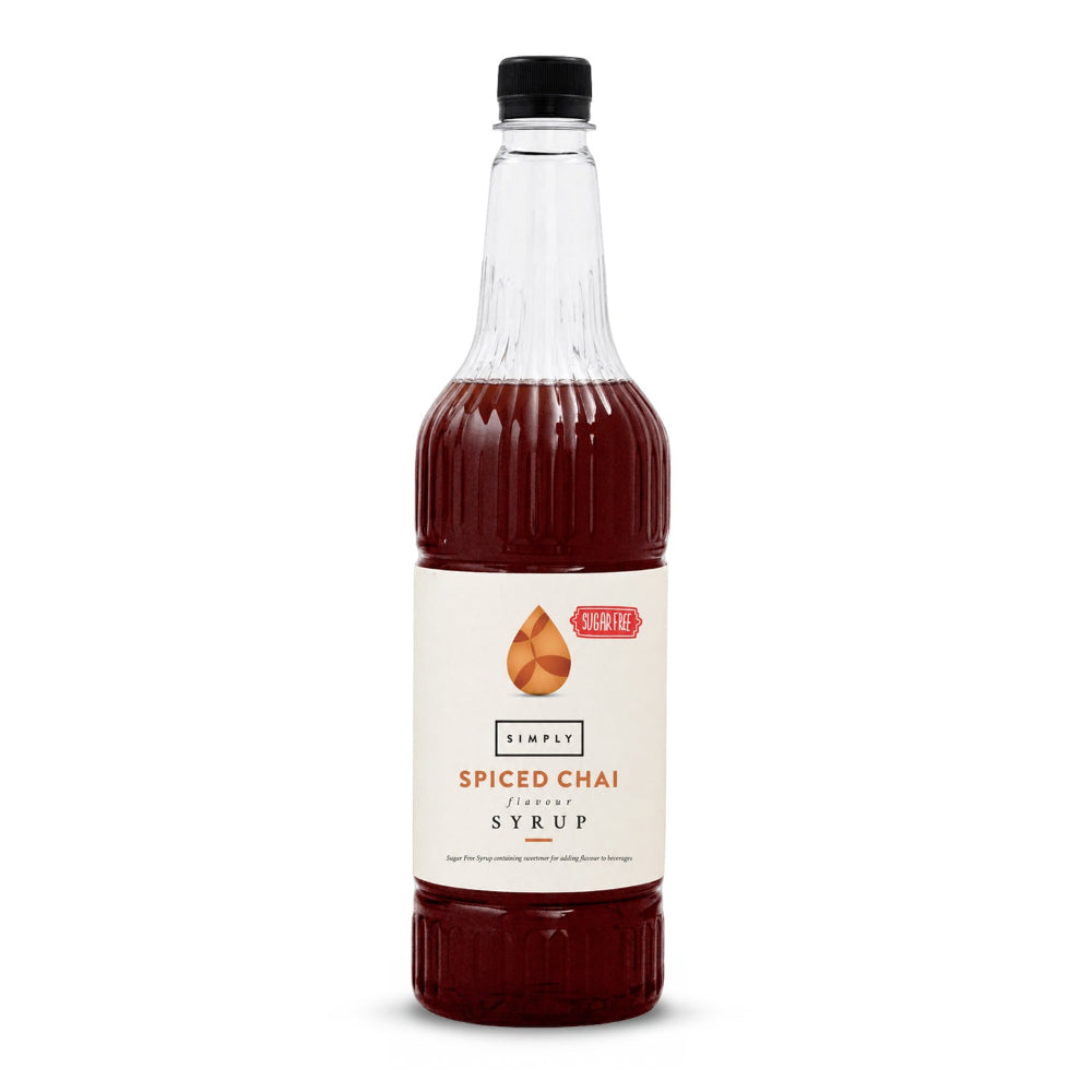 A 16 oz clear plastic bottle of Simply Spiced Chai Syrup filled with dark reddish-brown liquid, featuring a cream-colored label with orange and black text and a black cap, set against a plain white background.