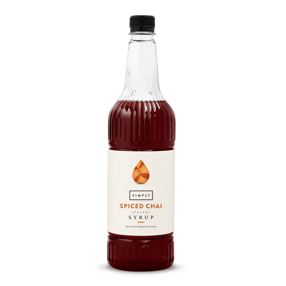 A bottle of Simply Spiced Chai Flavor Syrup with a cream label and orange logo, filled with dark reddish-brown syrup, on a white background.