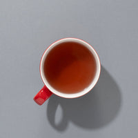 Cup of brewed Suki Red Berry caffeine-free fruit tea